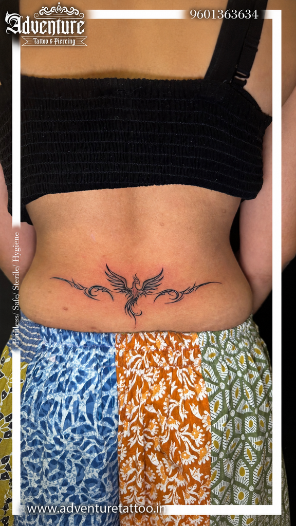 Phoenix Lower Back Tattoo for Women with fine-line tribal detailing
